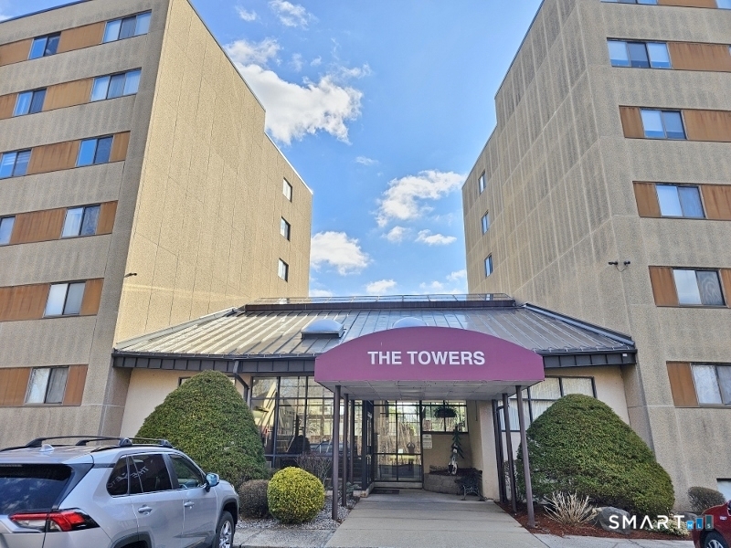 45 Putter Drive, Unit 509 Wallingford, CT 06492 - Photo 2 of 13 a view of a cafe with a table and chairs under an umbrella