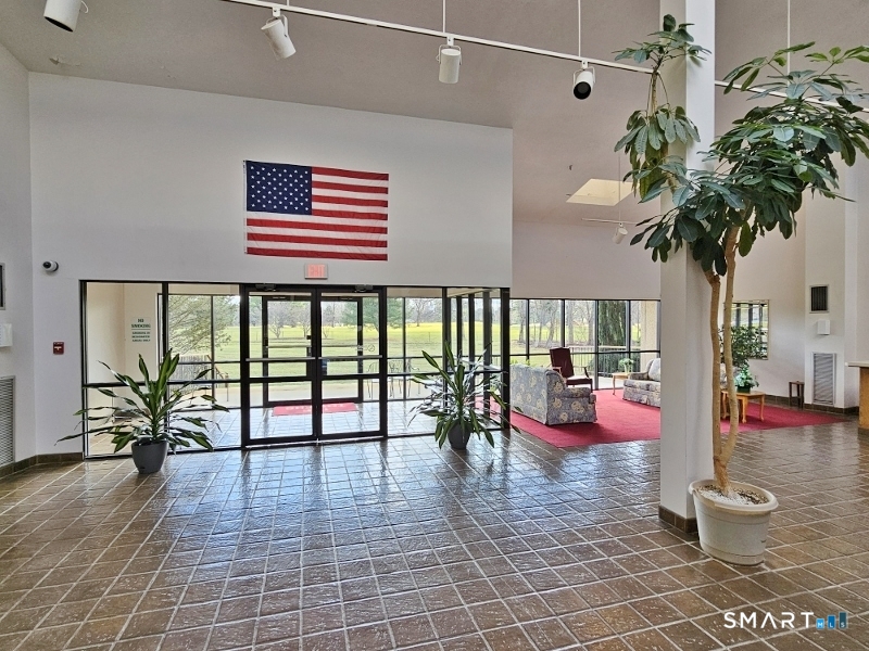 45 Putter Drive, Unit 509 Wallingford, CT 06492 - Photo 3 of 13 wooden floor with a potted plant in front of it