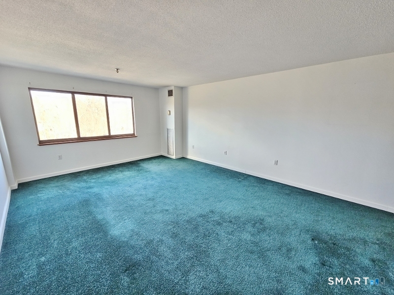 45 Putter Drive, Unit 509 Wallingford, CT 06492 - Photo 4 of 13 an empty room with a window