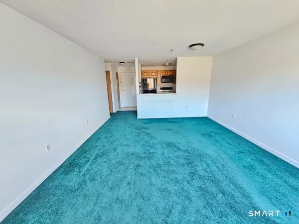 a view of a kitchen with a sink and a refrigerator