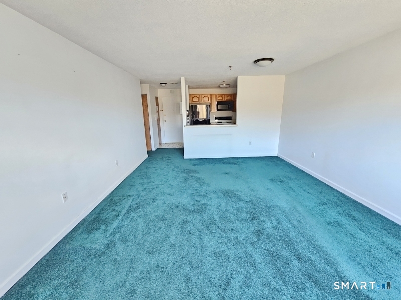 45 Putter Drive, Unit 509 Wallingford, CT 06492 - Photo 5 of 13 a view of a kitchen with a sink and a refrigerator