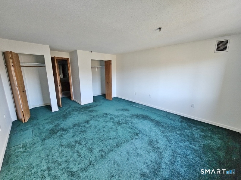 45 Putter Drive, Unit 509 Wallingford, CT 06492 - Photo 10 of 13 a view of an empty room with closet and stairs