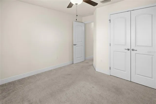 a living room with couch and a floor to ceiling window