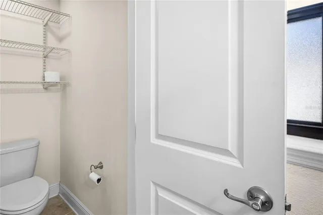a living room with patio furniture and a floor to ceiling window