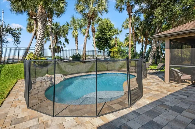 a view of a backyard with swimming pool