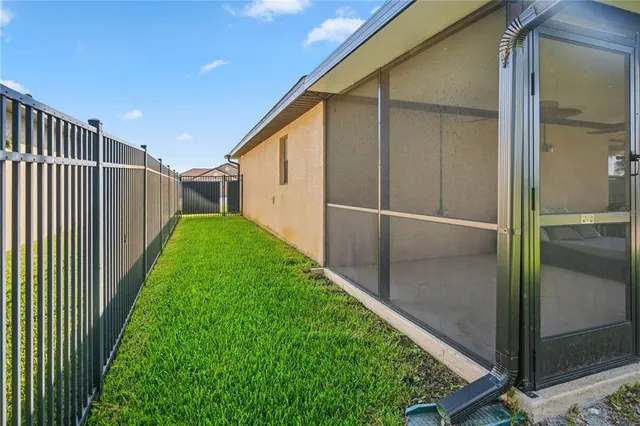 a view of a backyard with swimming pool