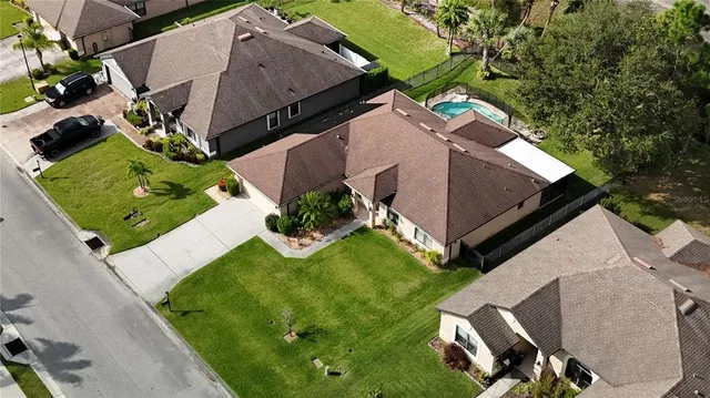 an aerial view of house with yard