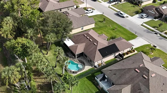 an aerial view of a house with a yard