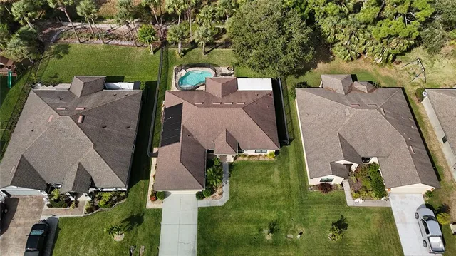 an aerial view of a house with a yard