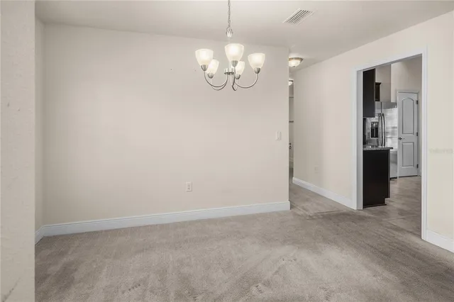 a view of kitchen with refrigerator and window