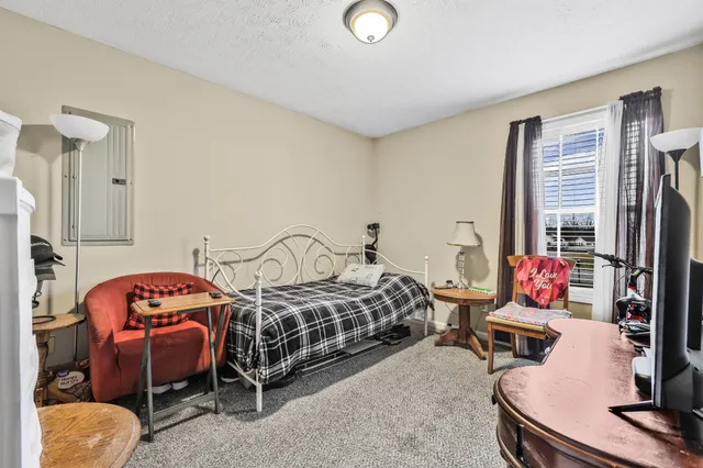 a bedroom with bed and a window