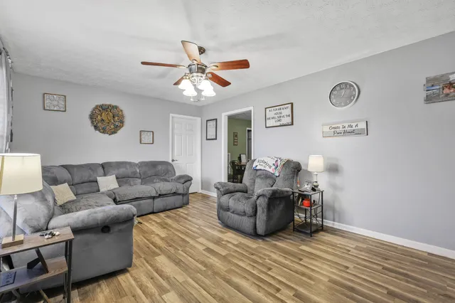a living room with furniture and a clock
