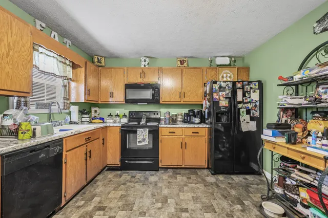 a kitchen with stainless steel appliances a stove a sink and a refrigerator
