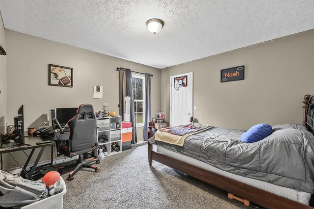 a bedroom with bed and a window