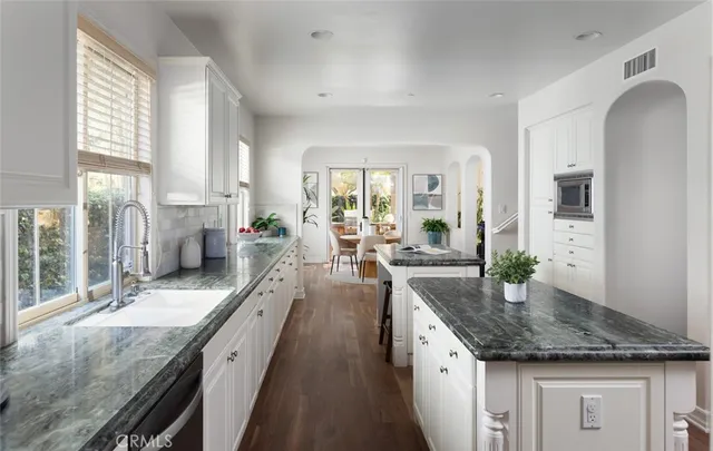 a large kitchen with granite countertop a lot of counter space