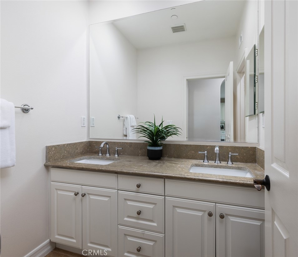 26 Via Fontibre San Clemente, CA 92673 - Photo 28 of 52 a bathroom with a granite countertop sink and white cabinets
