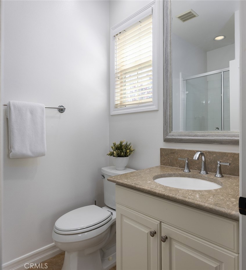 26 Via Fontibre San Clemente, CA 92673 - Photo 32 of 52 a bathroom with a granite countertop toilet sink and mirror