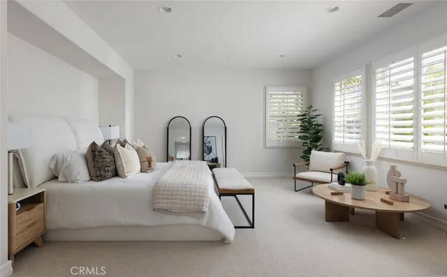 a bedroom with furniture and a window