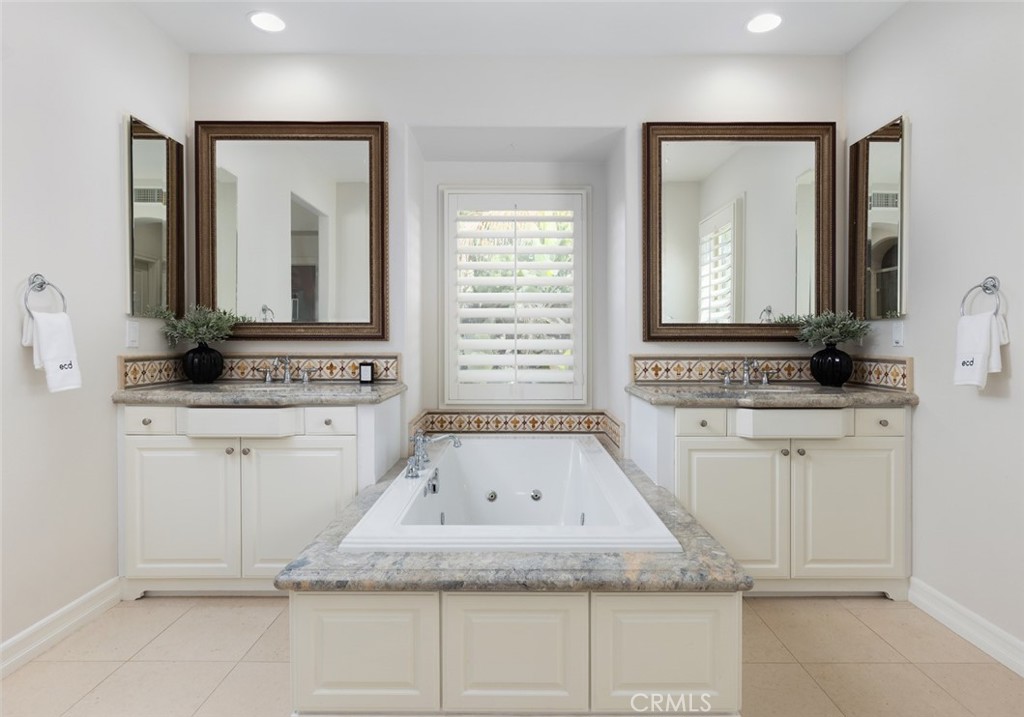 26 Via Fontibre San Clemente, CA 92673 - Photo 35 of 52 a bathroom with a granite countertop sink and a mirror