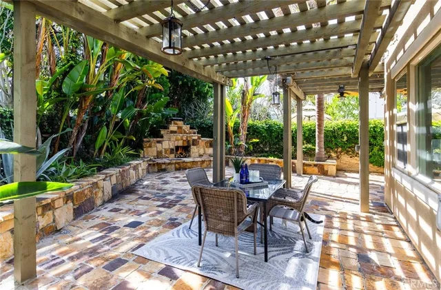 a view of a patio with table and chairs and floor to ceiling window