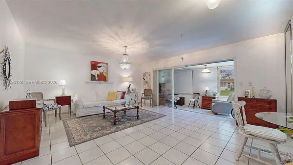 a living room with furniture a dining table and chairs with wooden floor