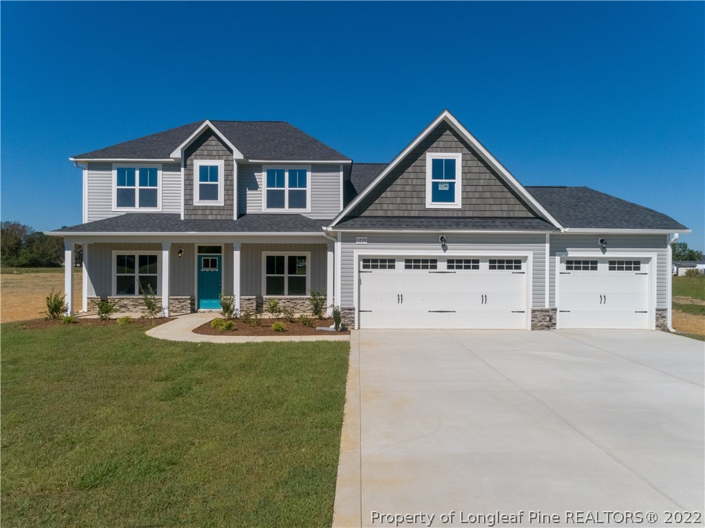 5229 Bree Bridge Road Hope Mills, NC 28348 - Photo 1 of 18 a front view of a house with swimming pool having outdoor seating