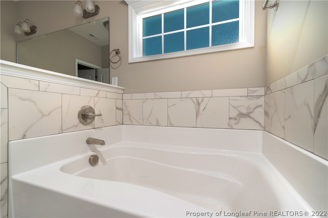 5229 Bree Bridge Road Hope Mills, NC 28348 - Photo 11 of 18 a bathroom with a bathtub