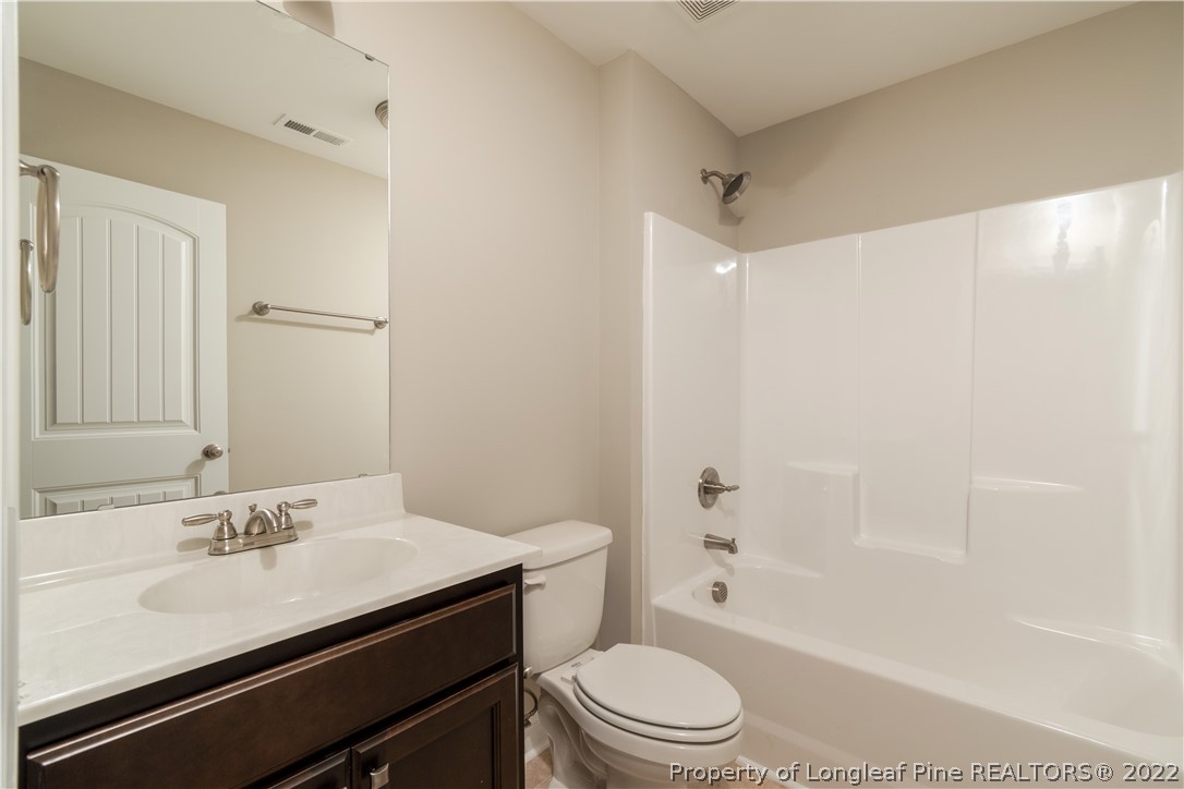 5229 Bree Bridge Road Hope Mills, NC 28348 - Photo 16 of 18 a bathroom with a sink a toilet and shower