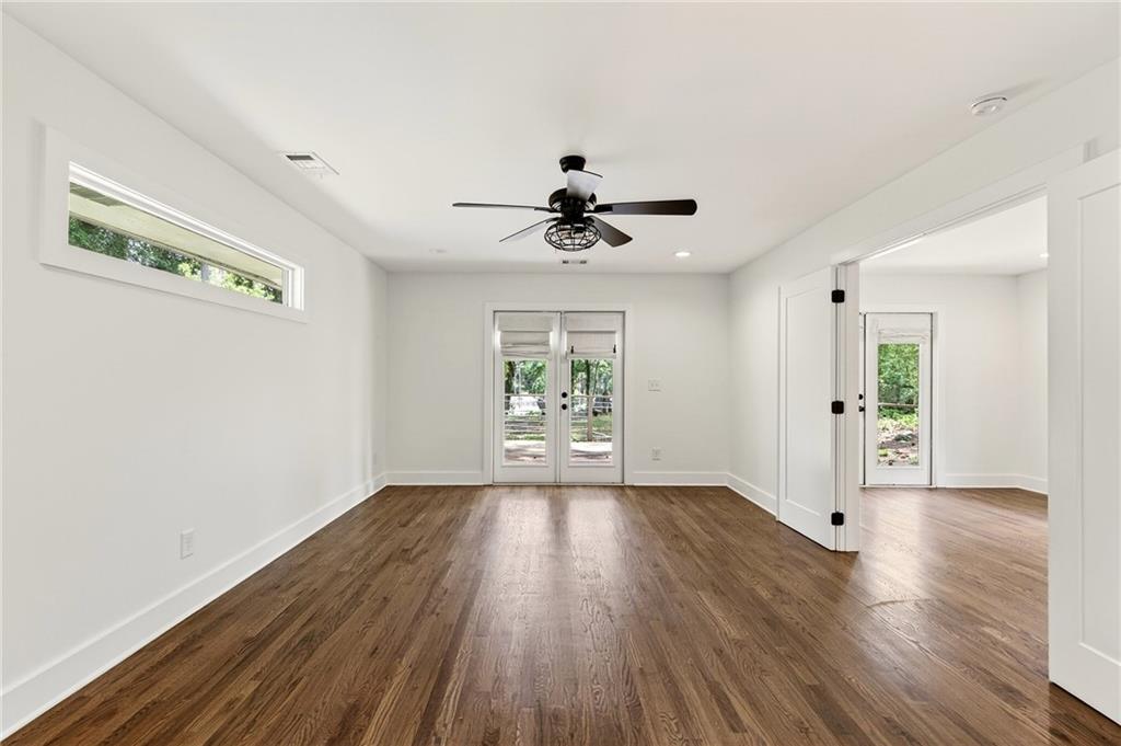 1344 Midlawn Drive Decatur, GA 30032 - Photo 52 of 87 a view of an empty room with a window and wooden floor