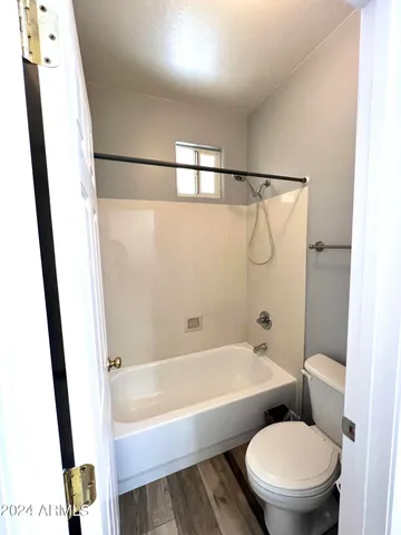 a bathroom with a double vanity sink toilet mirror and bathtub