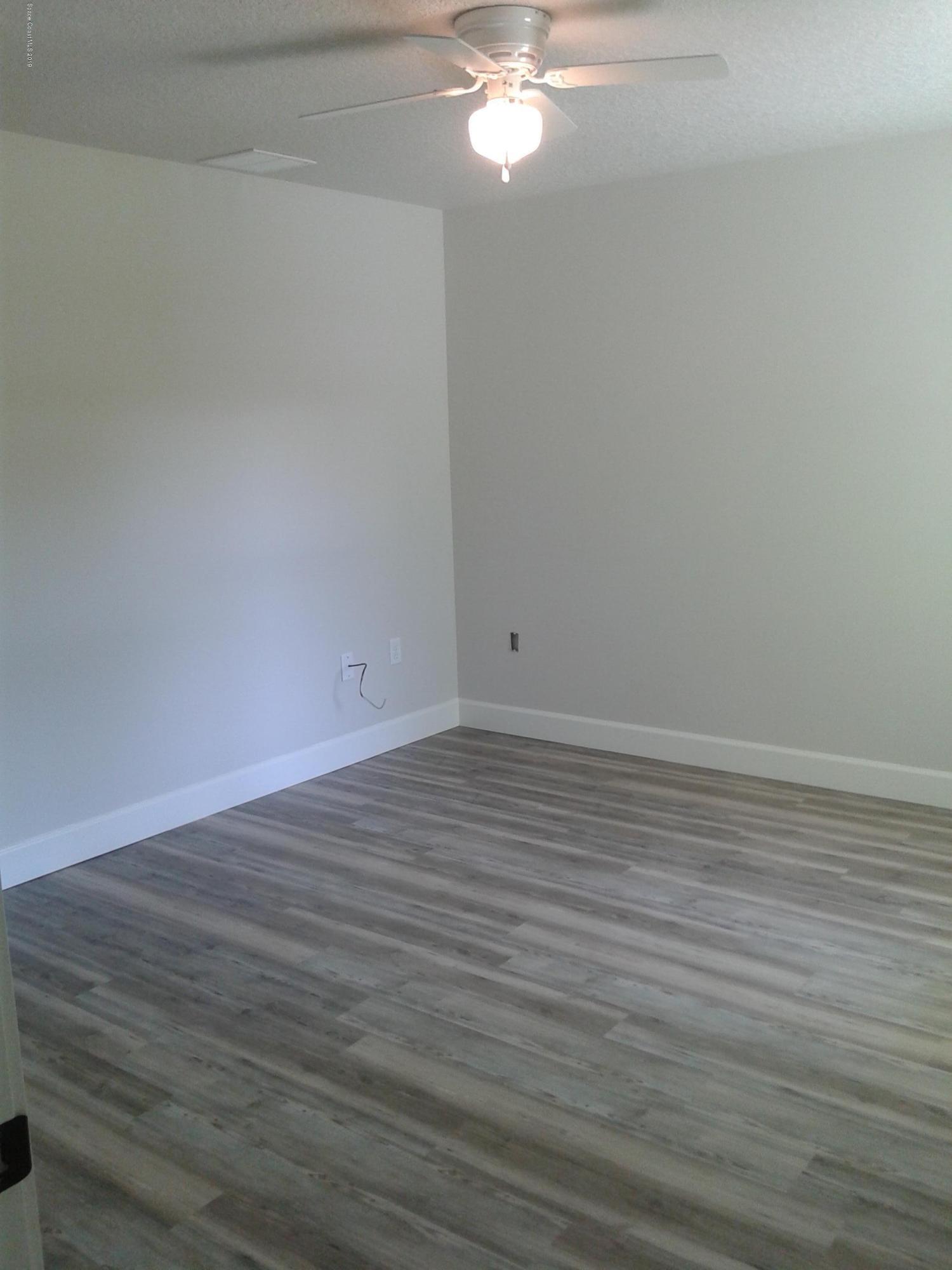 1851 Keewin Avenue, Unit 2 Palm Bay, FL 32905 - Photo 11 of 15 a view of an empty room with wooden floor