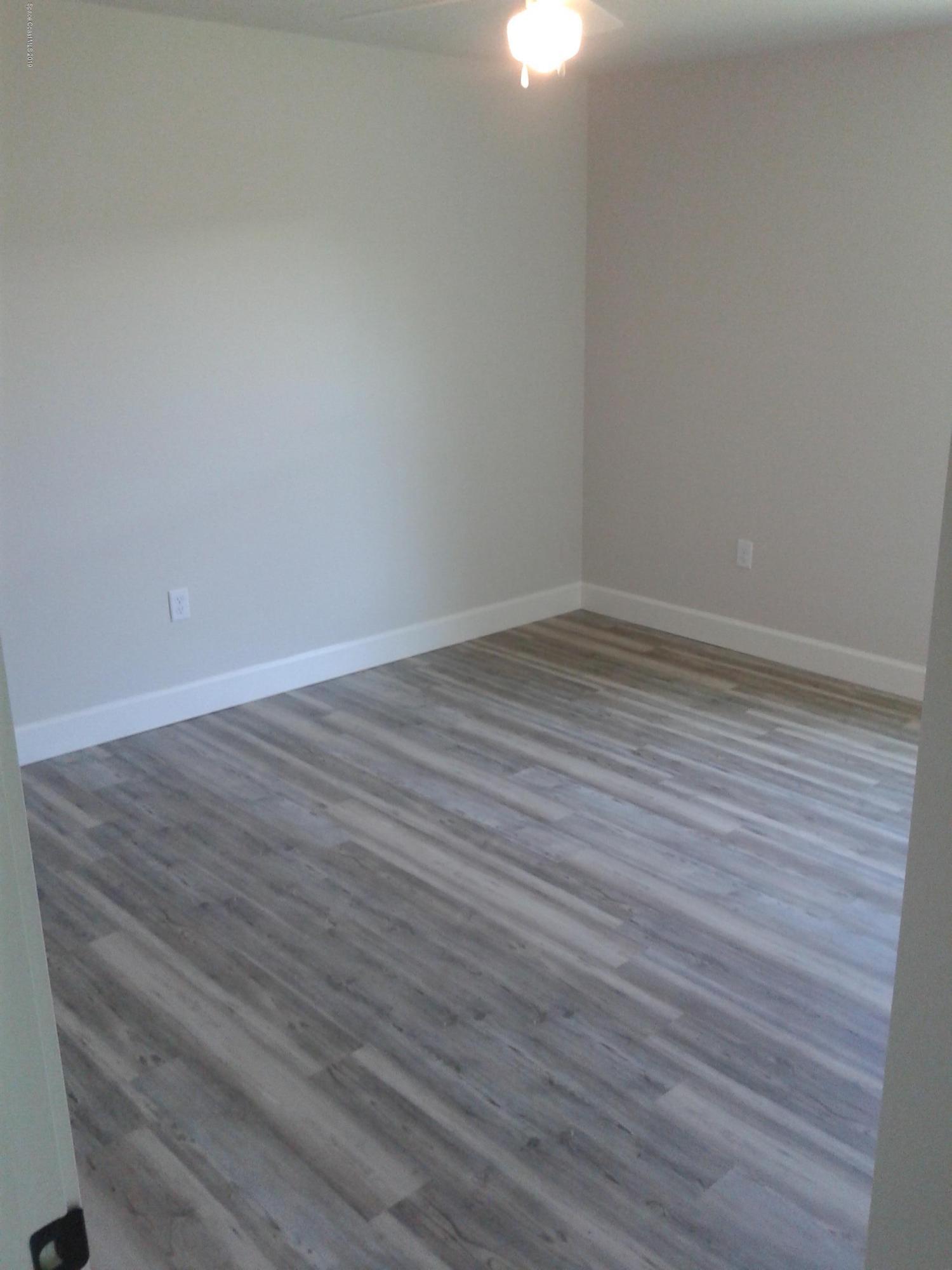 1851 Keewin Avenue, Unit 2 Palm Bay, FL 32905 - Photo 13 of 15 wooden floor in a empty room