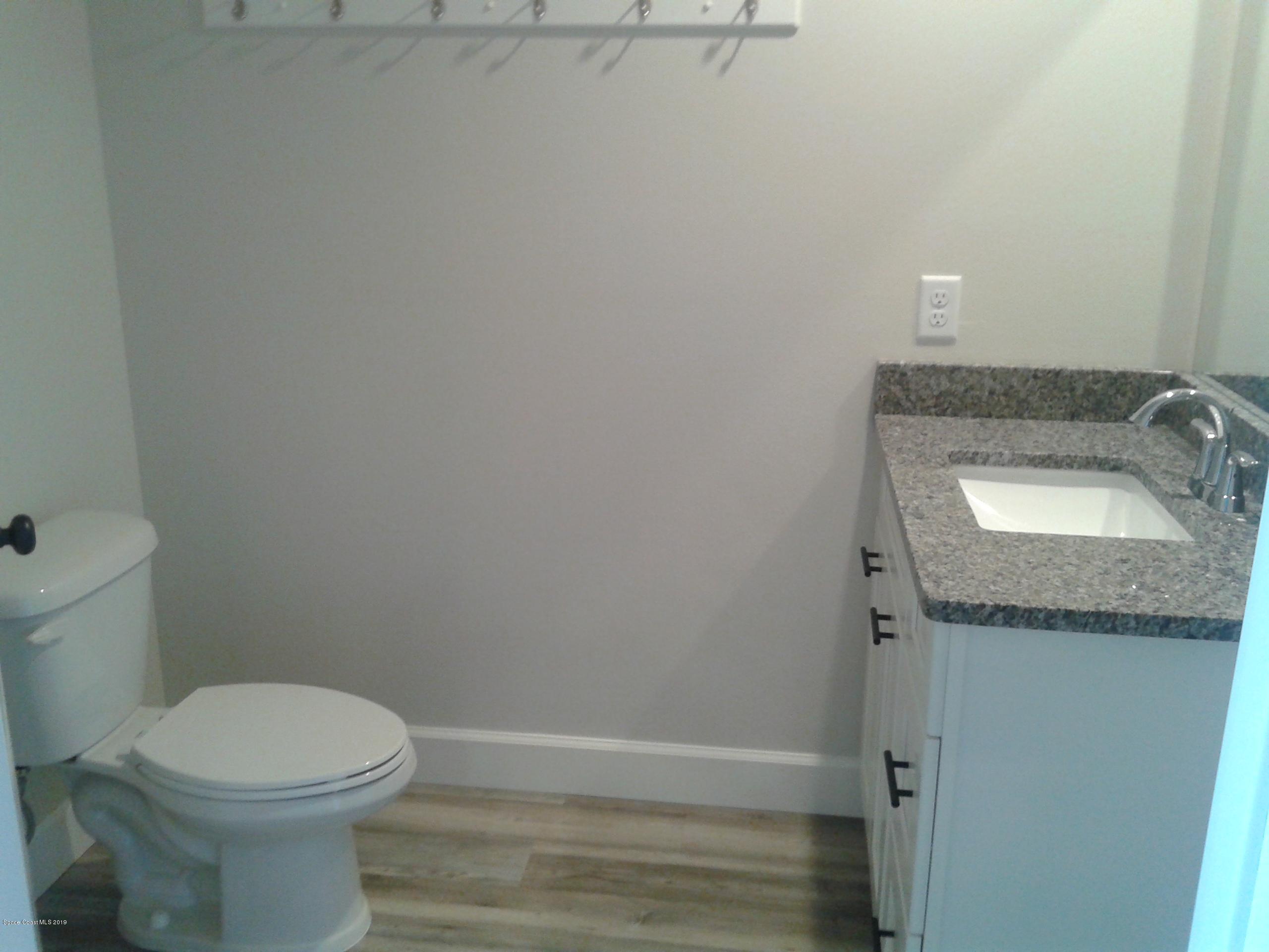 1851 Keewin Avenue, Unit 2 Palm Bay, FL 32905 - Photo 8 of 15 a bathroom with a granite countertop sink and toilet