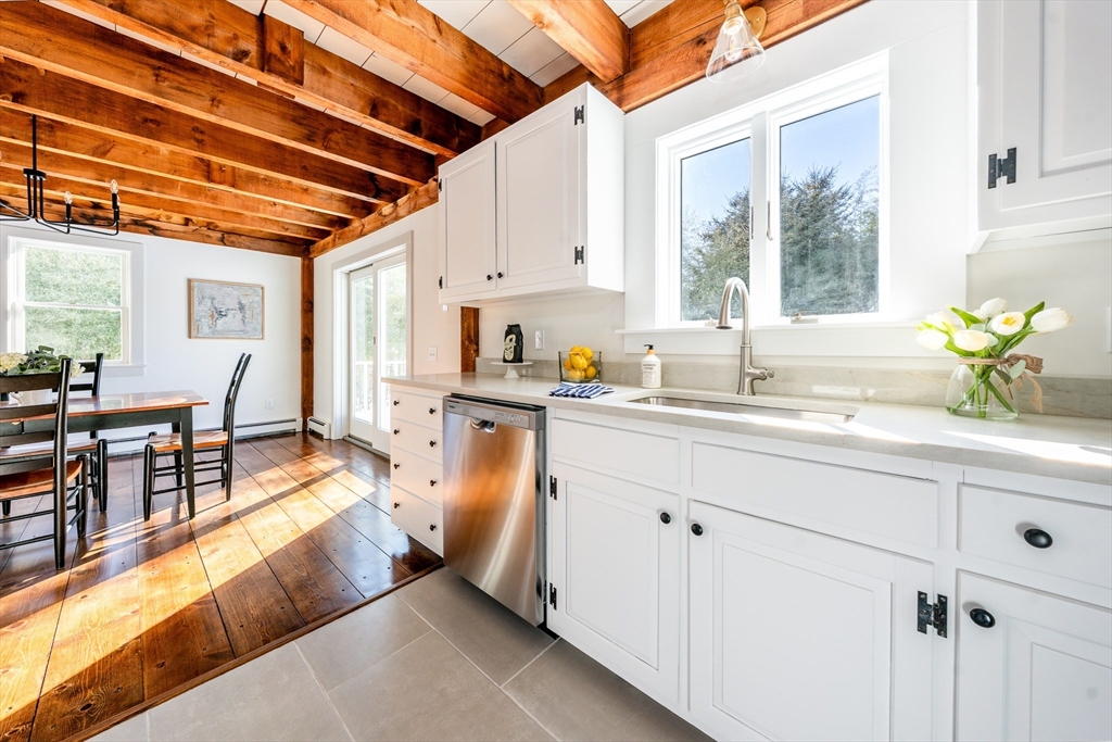 80 Branch Terrace Barnstable, MA 02648 - Photo 12 of 38 a spacious white kitchen with stainless steel appliances granite countertop a sink window and cabinets
