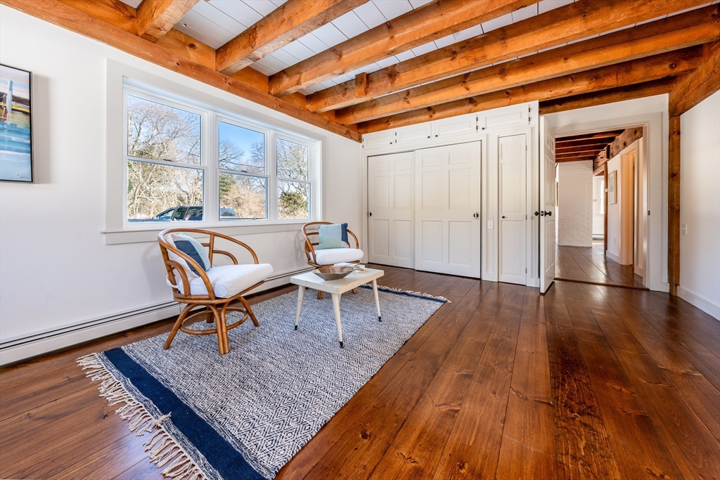 80 Branch Terrace Barnstable, MA 02648 - Photo 18 of 38 a dining room with wooden floor and a rug