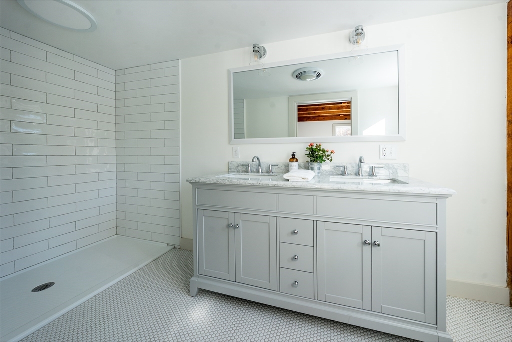 80 Branch Terrace Barnstable, MA 02648 - Photo 23 of 38 a bathroom with a sink tub vanity and a mirror