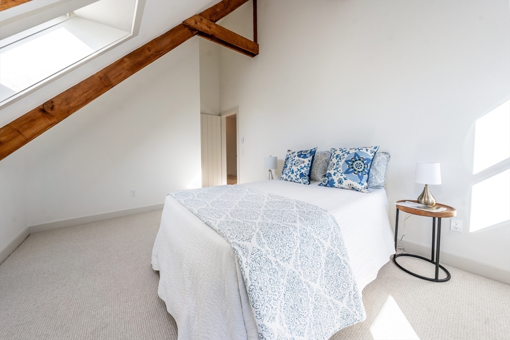 80 Branch Terrace Barnstable, MA 02648 - Photo 30 of 38 a bedroom with a bed and painting on the wall