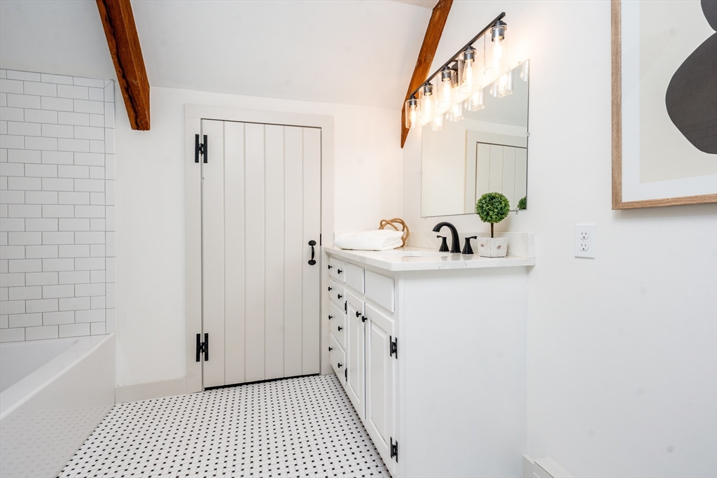 80 Branch Terrace Barnstable, MA 02648 - Photo 32 of 38 a bathroom with a sink a mirror and a bathtub
