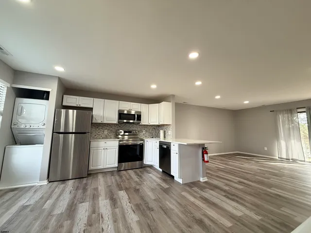 a kitchen with a refrigerator and a sink