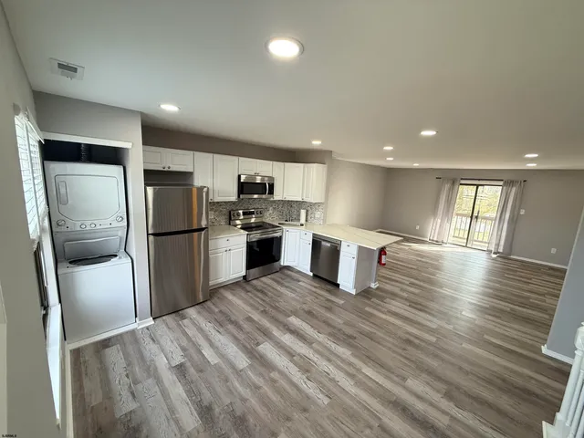 a kitchen with stainless steel appliances a refrigerator sink and stove