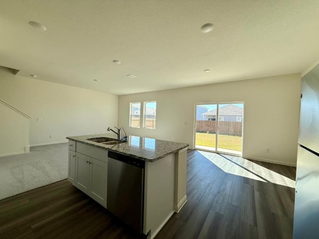 1109 Delta Crest Maxwell, TX 78656 - Photo 3 of 21 an empty room with wooden floor and windows