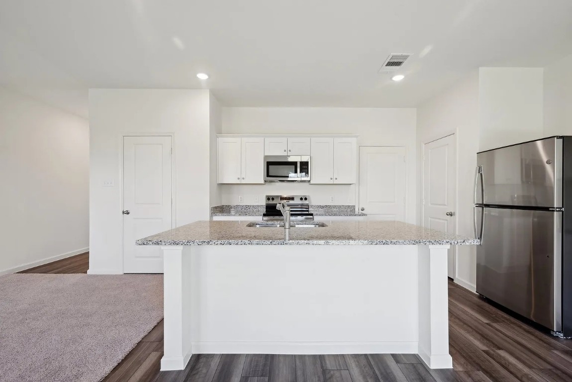 1109 Delta Crest Maxwell, TX 78656 - Photo 6 of 21 a kitchen with stainless steel appliances granite countertop a refrigerator a sink a stove a microwave and island