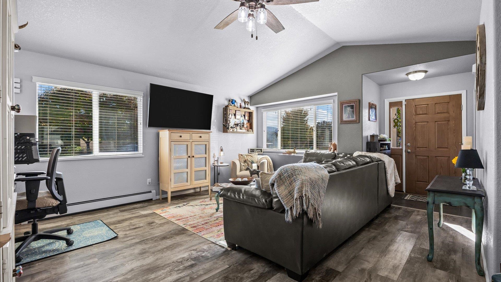 182 Woodstock Street Fruita, CO 81521 - Photo 13 of 31 a bed room with furniture and a flat screen tv