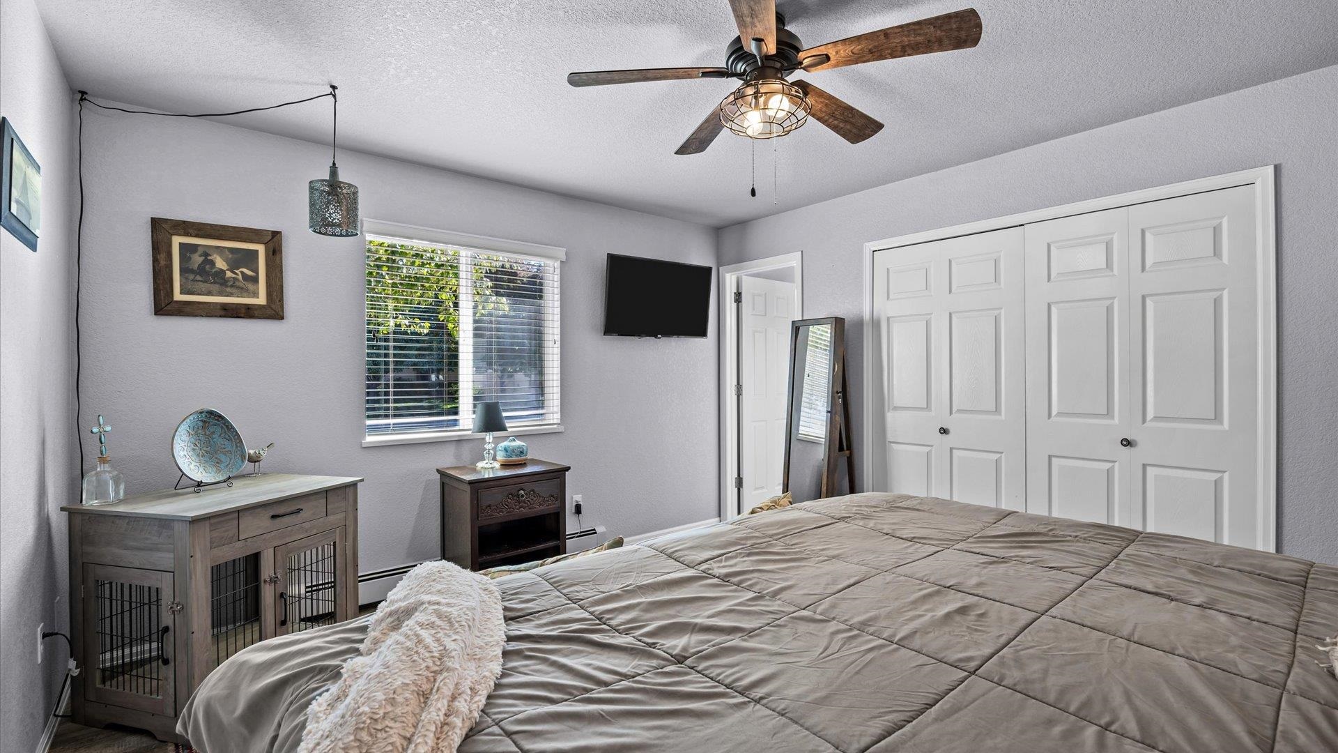 182 Woodstock Street Fruita, CO 81521 - Photo 20 of 31 a bedroom with a bed and a chandelier