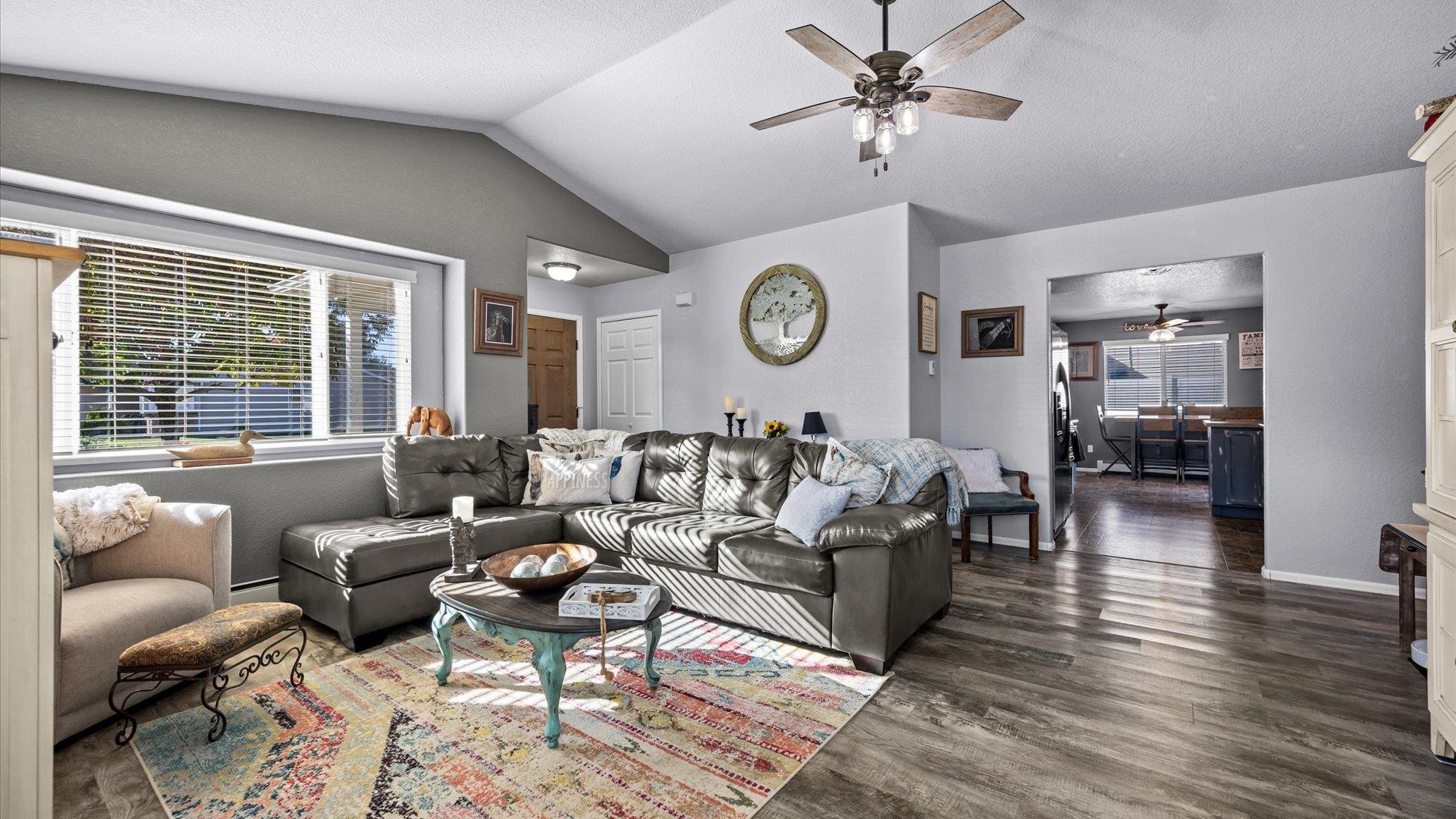 182 Woodstock Street Fruita, CO 81521 - Photo 2 of 31 a living room with furniture a clock on wall and a large window