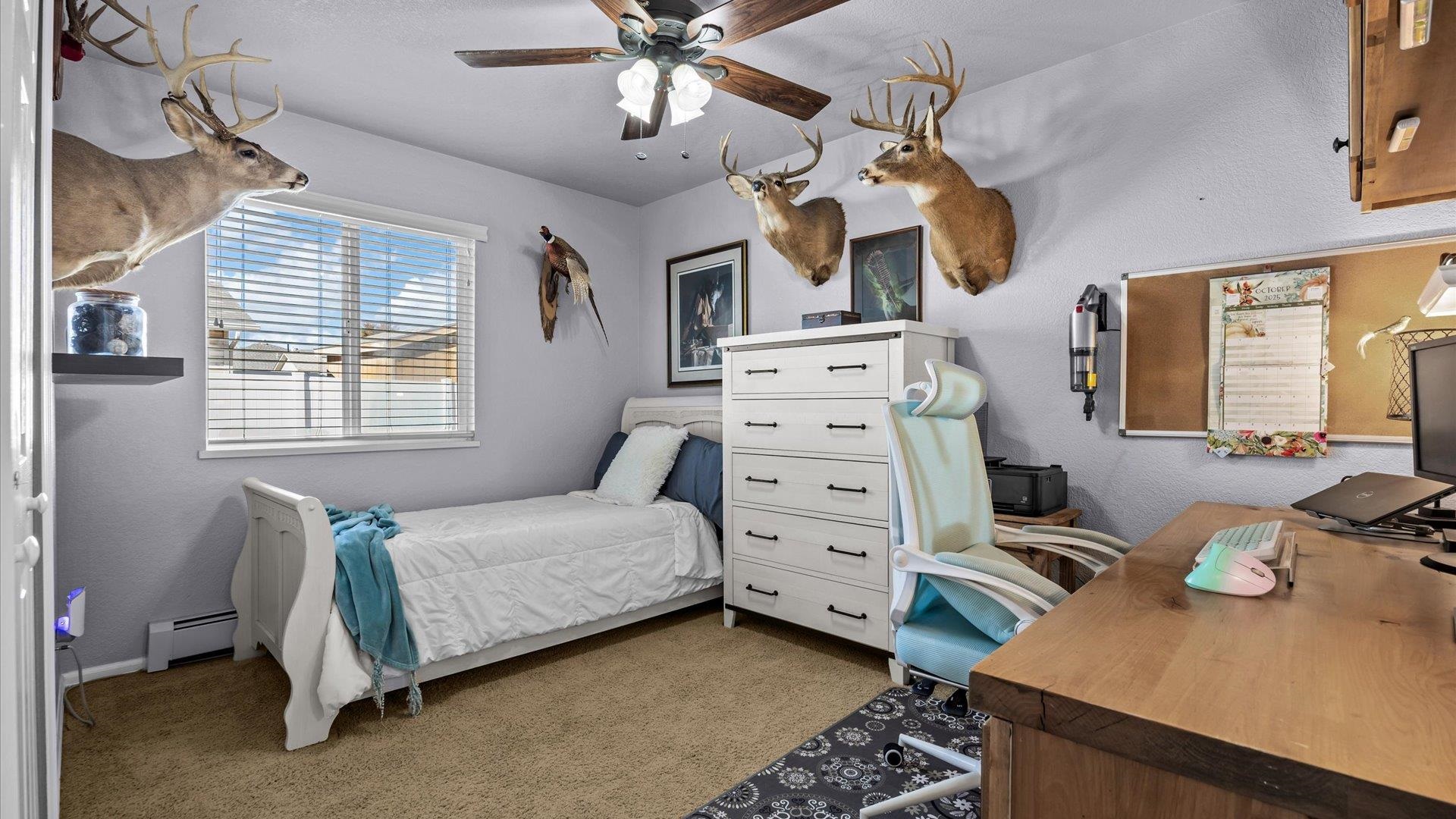 182 Woodstock Street Fruita, CO 81521 - Photo 22 of 31 a bedroom with a bed and wooden floor