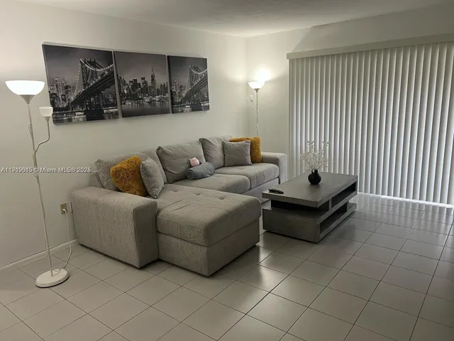 a living room with furniture and wall painting