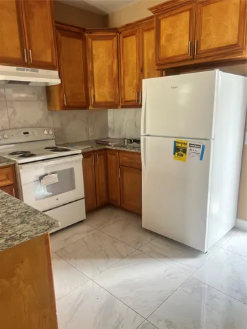 a white refrigerator freezer sitting in a kitchen