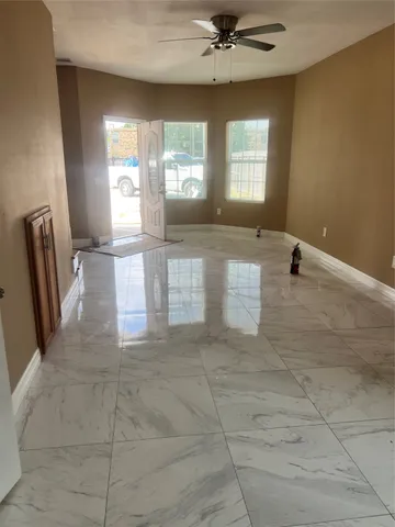 a view of an empty room with a window