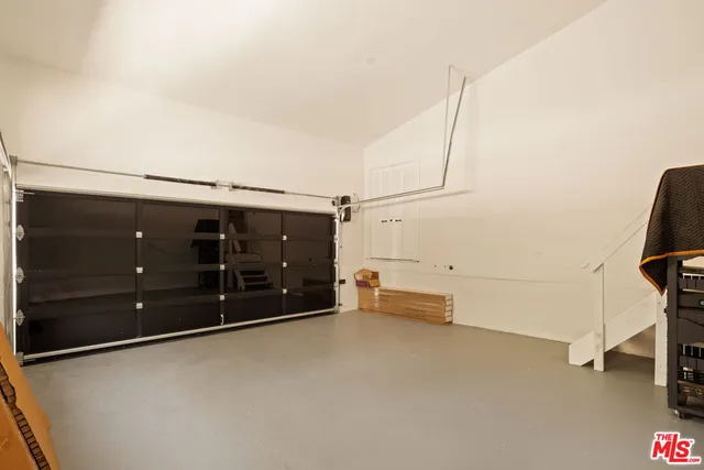 a view of a backyard with swimming pool and sitting area